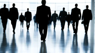 Business Professionals Walking Through A Bright Modern Office Hallway
