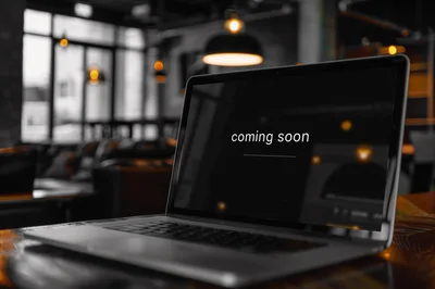 Laptop Displaying Coming Soon Text In A Cafe