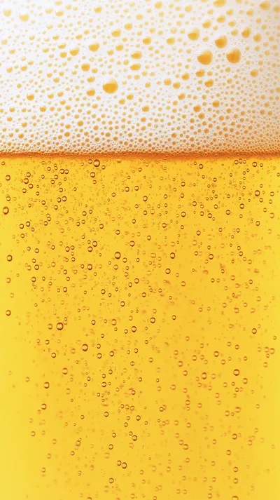 Macro Shot Of Golden Beer With Rising Bubbles