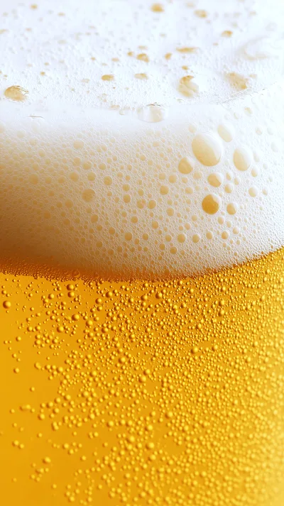Close Up Of Golden Beer With Bubbles And Foam