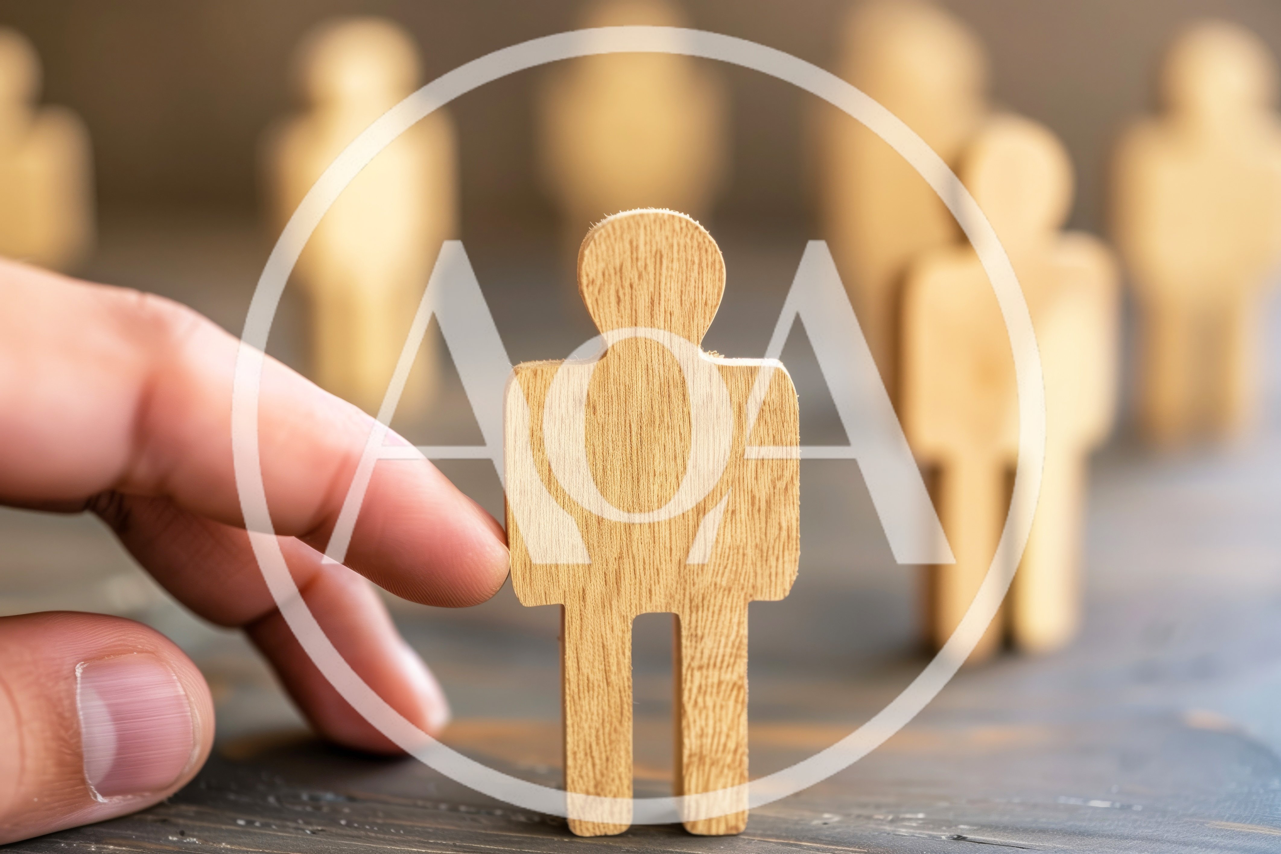 Hand Selecting A Wooden Human Figure From A Group