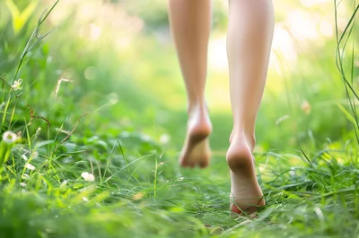 Barefoot Woman Walking Through Lush Green Grass