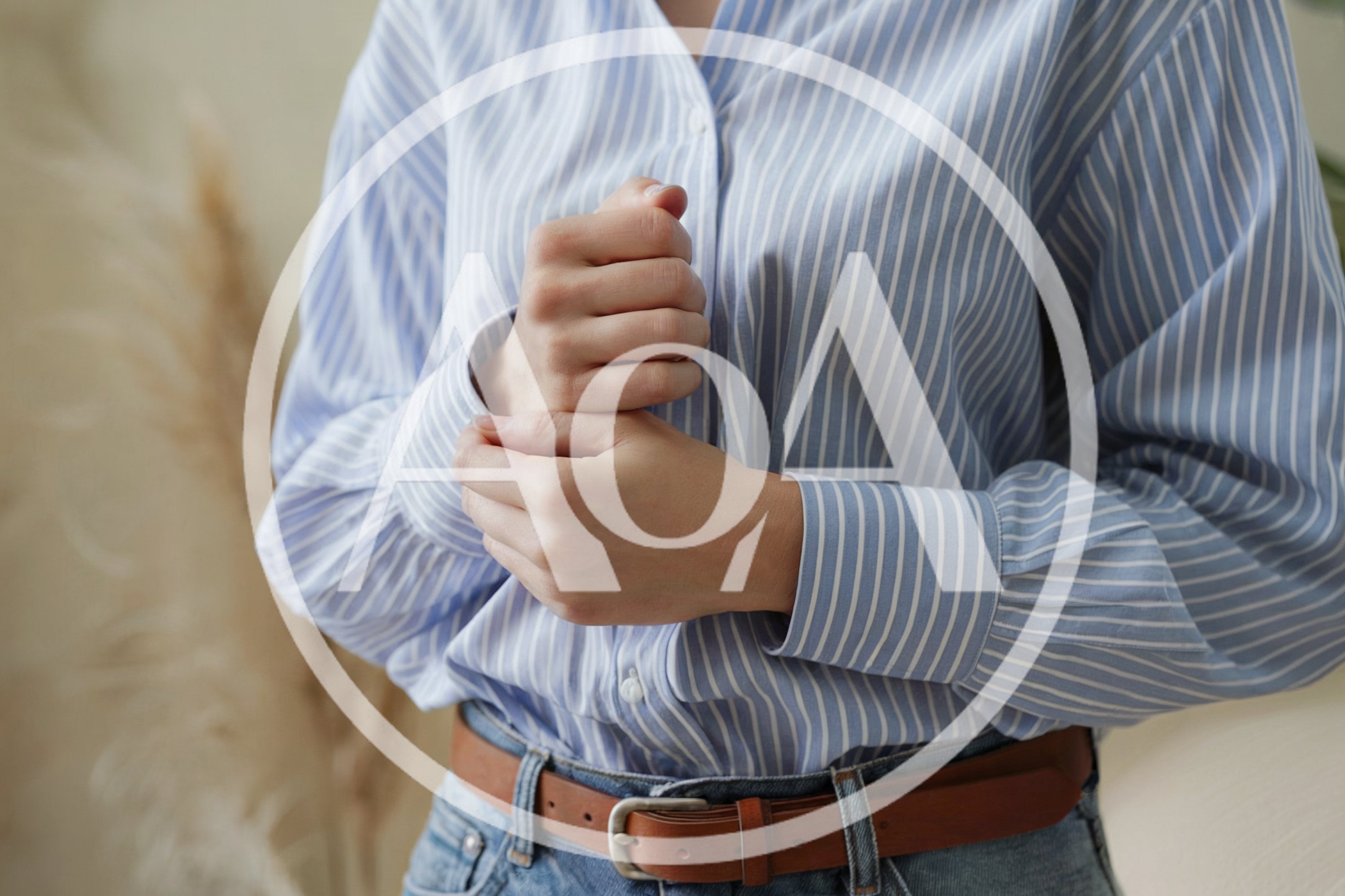 Woman Adjusting Her Striped Button Down Shirt Cuffs