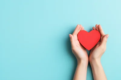 Hands Holding A Red Heart Shape