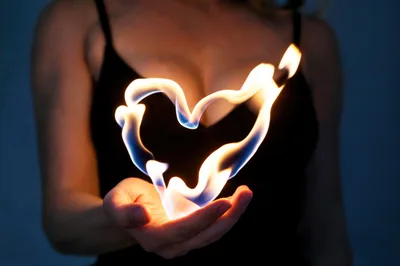 Woman Holding A Glowing Heart Shaped Flame