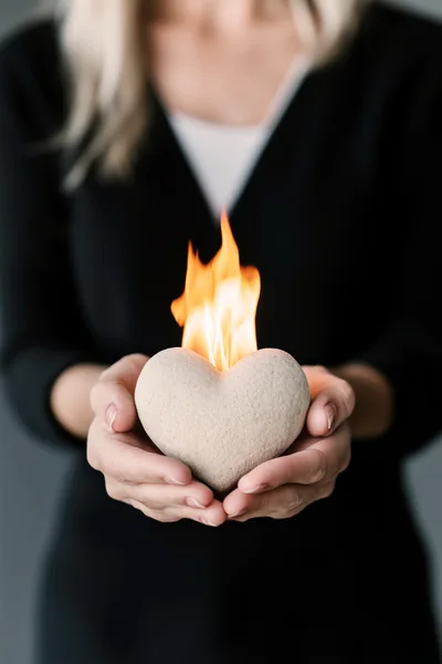 Woman Holding A Burning Stone Heart