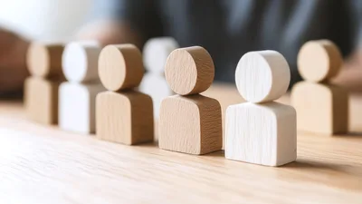 Wooden Human Figurines Arranged On A Wooden Table