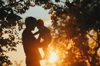 Father Holding His Baby During Golden Hour Sunset