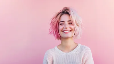 Young Woman With Pink Hair Smiling Against Pink Background