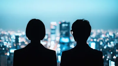 Silhouetted Business Professionals Looking Out Over City Skyline