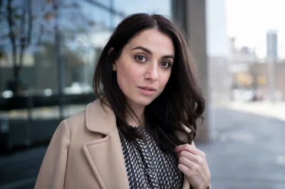 Portrait Of A Young Woman In A Beige Coat