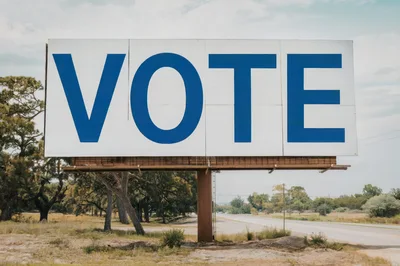 Large Billboard With The Word Vote In Rural Landscape