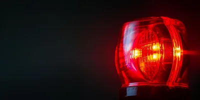 Red Emergency Warning Light Flashing In Darkness