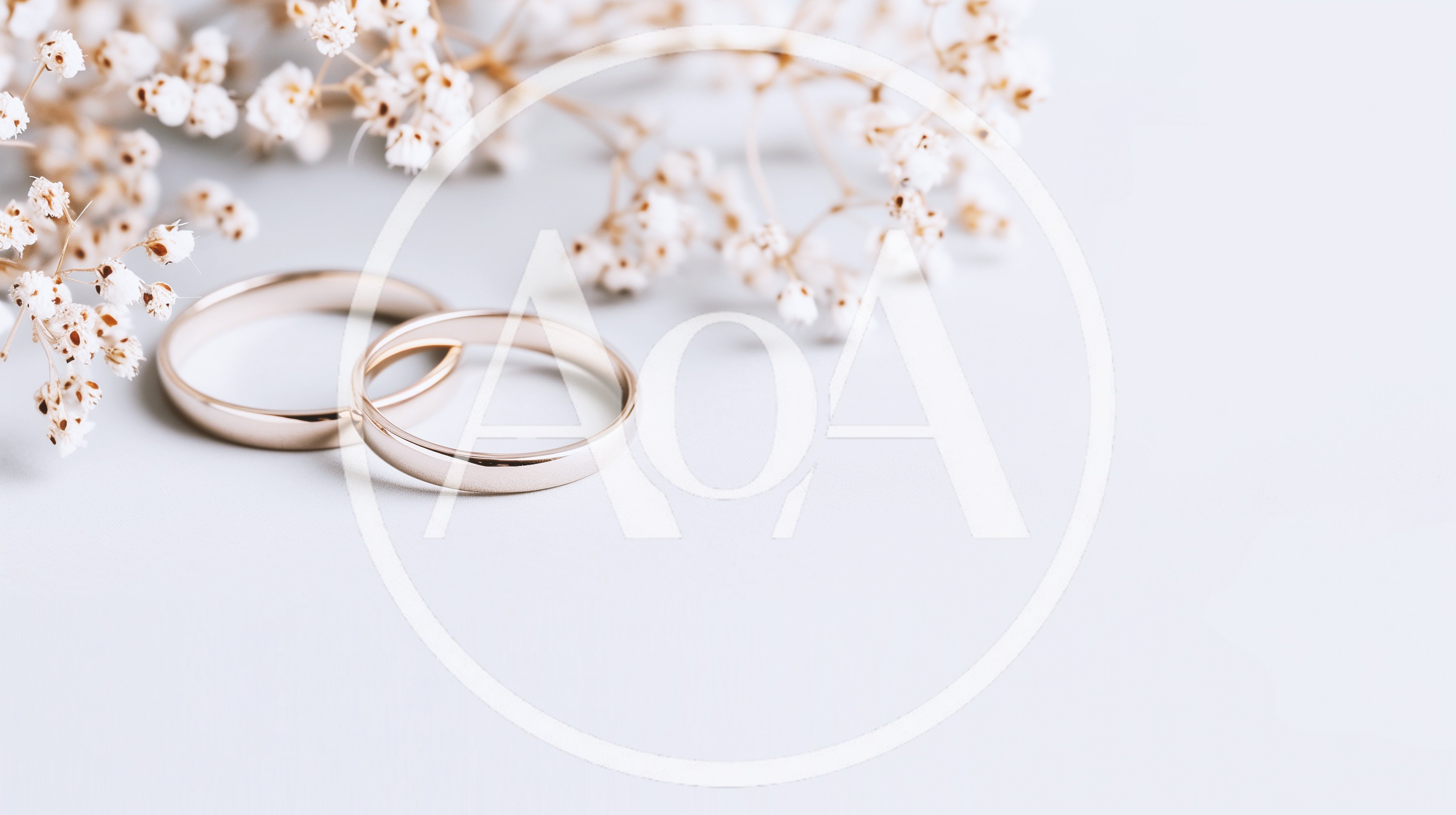 Two Gold Wedding Rings With Baby Breath Flowers