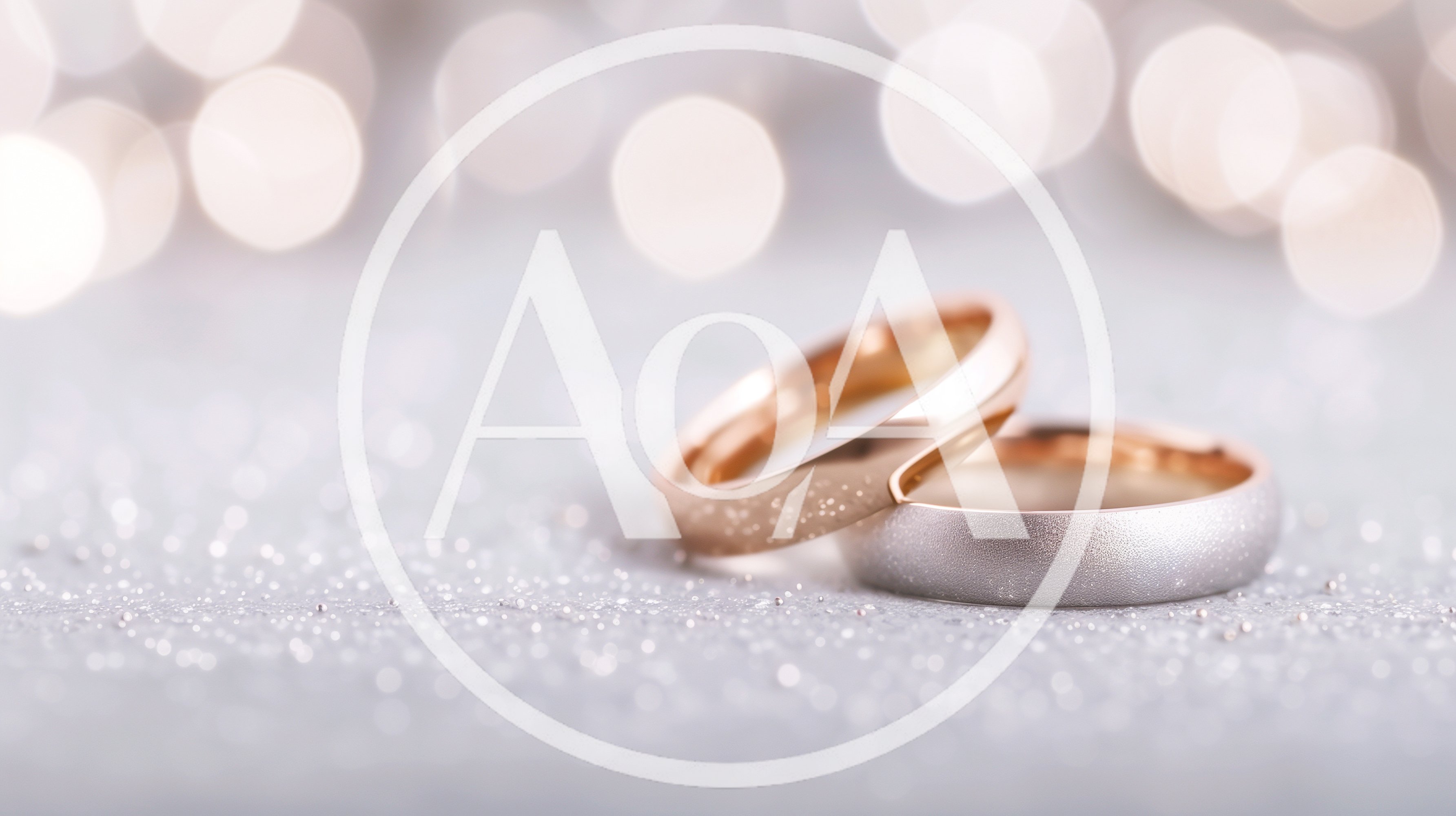 Two Wedding Rings Resting On A Glittering Surface