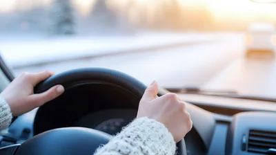 Woman Driving Car On Snowy Winter Road