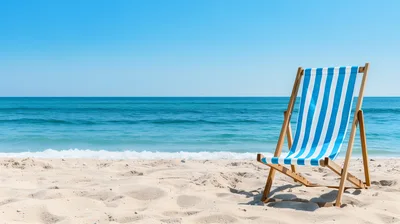 Blue and White Striped Beach Chair on Sandy Shore