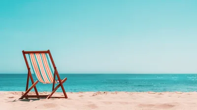 Empty Striped Beach Chair On Sandy Shore