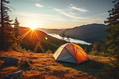Camping Tent Overlooking A Mountain Lake At Sunrise