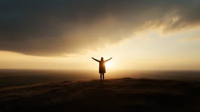 Silhouette Of A Woman Standing With Arms Outstretched