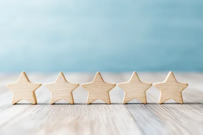 Five Wooden Stars Arranged In A Row