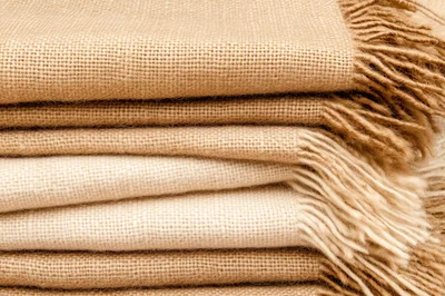Stack Of Folded Textured Burlap Fabric Blankets