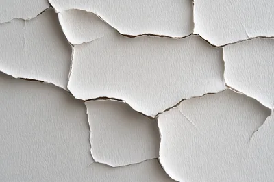 Cracked White Paint Texture On A Wall Surface