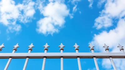 White Metal Fence Against Blue Sky