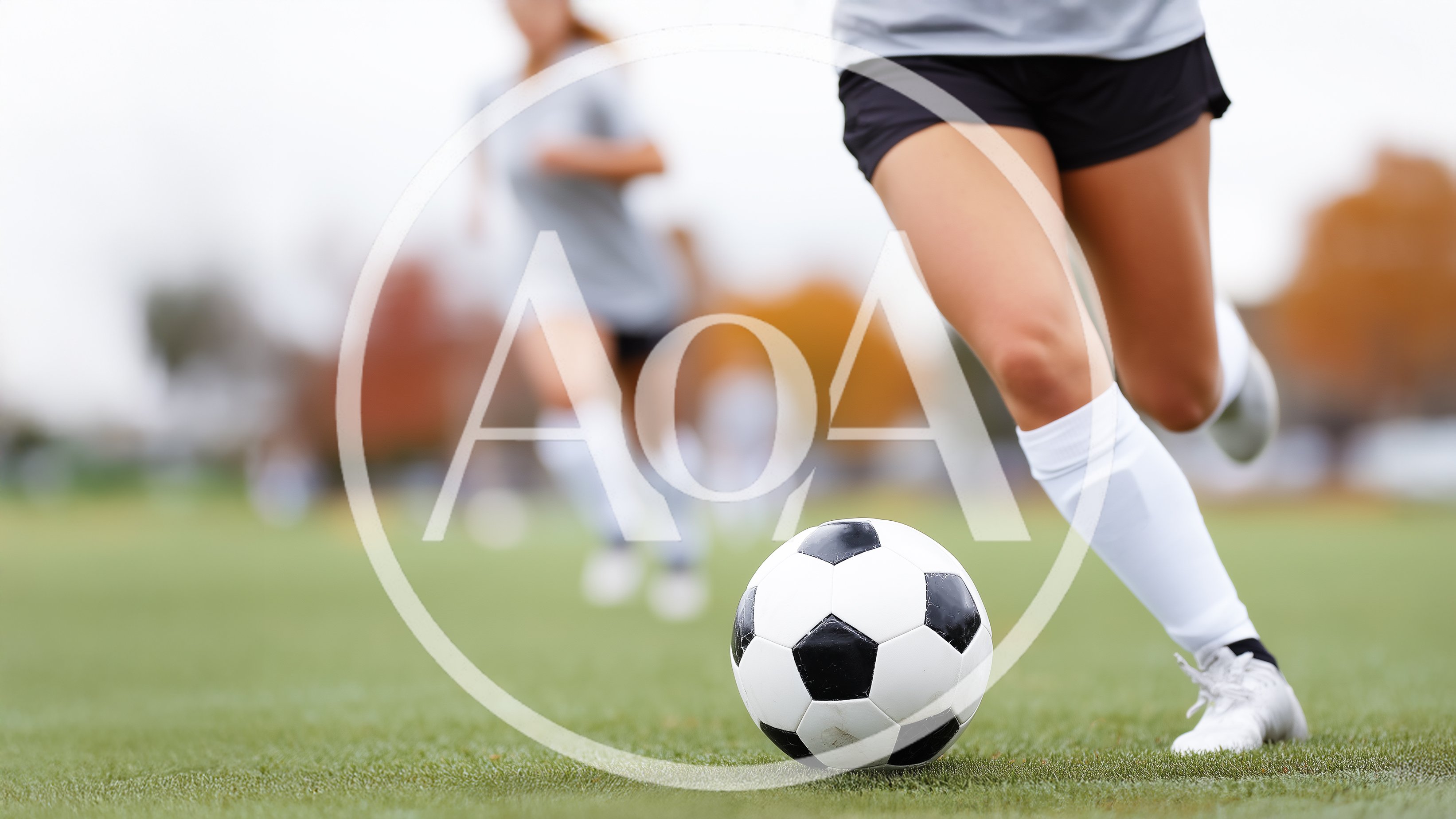 Female Soccer Player Dribbling Ball on Field