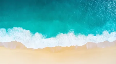 Aerial View Of Turquoise Ocean Waves Hitting Sandy Beach