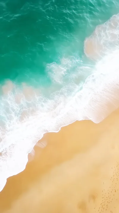Aerial View Of Turquoise Ocean Waves Hitting Sandy Beach