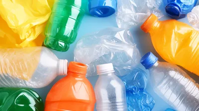 Assorted Plastic Bottles and Waste on Blue Background
