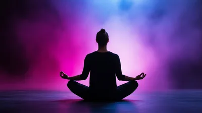 Silhouette Of A Woman Meditating In Lotus Pose