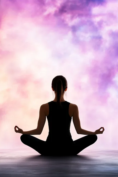 Silhouette Of A Woman Meditating In Lotus Pose