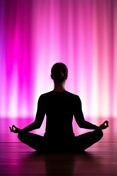 Silhouette Of A Woman Meditating In Lotus Position
