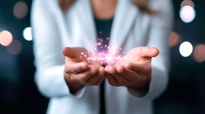 Businesswoman Holding Glowing Digital Particles In Hands