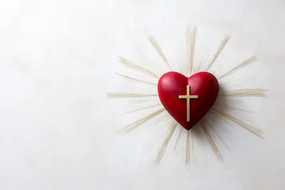 Red Heart With Gold Cross And Radiant Light Rays