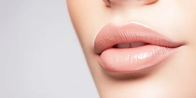 Close Up Of Woman With Glossy Nude Lips