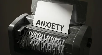 Paper Shredder Destroying A Document Labeled Anxiety