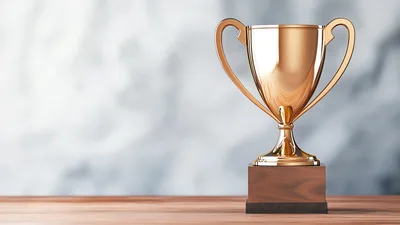 Golden Trophy Cup On Wooden Surface