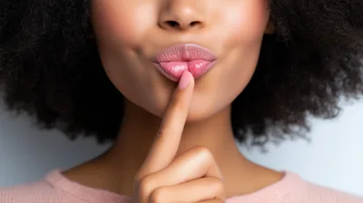 Young Woman Making A Quiet Gesture With Her Finger
