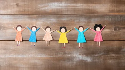 Paper Cutout Dolls Holding Hands On Wooden Background