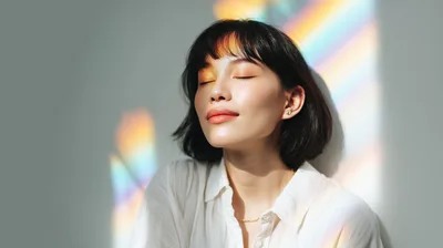 Young Woman With Rainbow Light Reflection On Face