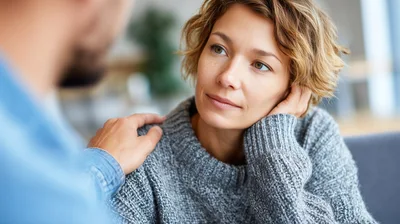 Man Comforting Woman During A Serious Conversation