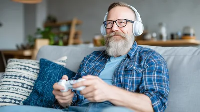 Senior Man Playing Video Games At Home