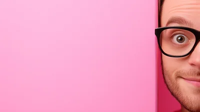 Man Peeking From Behind A Pink Wall