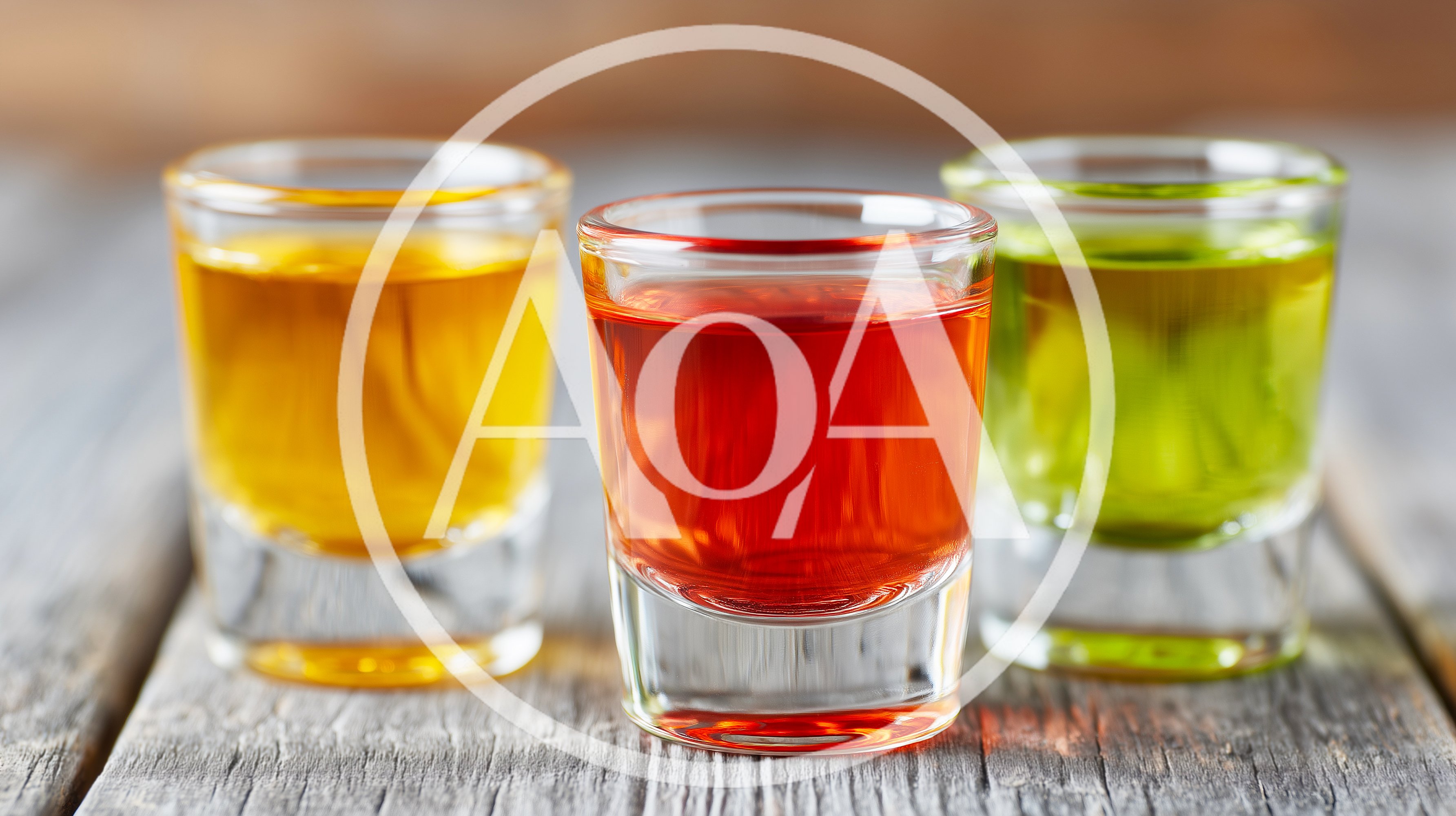 Three Colorful Shot Glasses On A Wooden Table