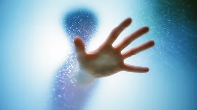 Person Pressing Hand Against Frosted Glass Shower Door