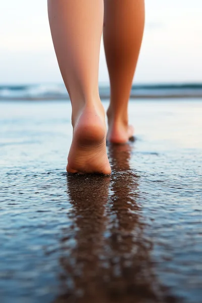 Barefoot Woman Walking Along The Wet Sandy Beach