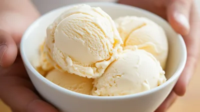 Hands Holding A Bowl Of Vanilla Ice Cream